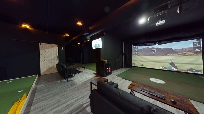 Bay 1 lounge area at Club X Indoor Golf — corporate event setup capacity